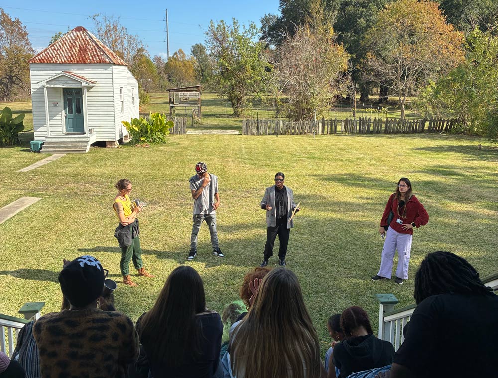 11. Field trip with New Harmony High School juniors and seniors; December 2025. We led students on a psychogeographic walk, an exploratory and grounding somatic exercise, and a historic tour of the house, sharing our three programmatic and exhibition themes: the Plantation-to-Petrochemical Corridor, the 1811 German Coast Uprising, and the legacy of Creole jazz trombonist, Edward “Kid” Ory.